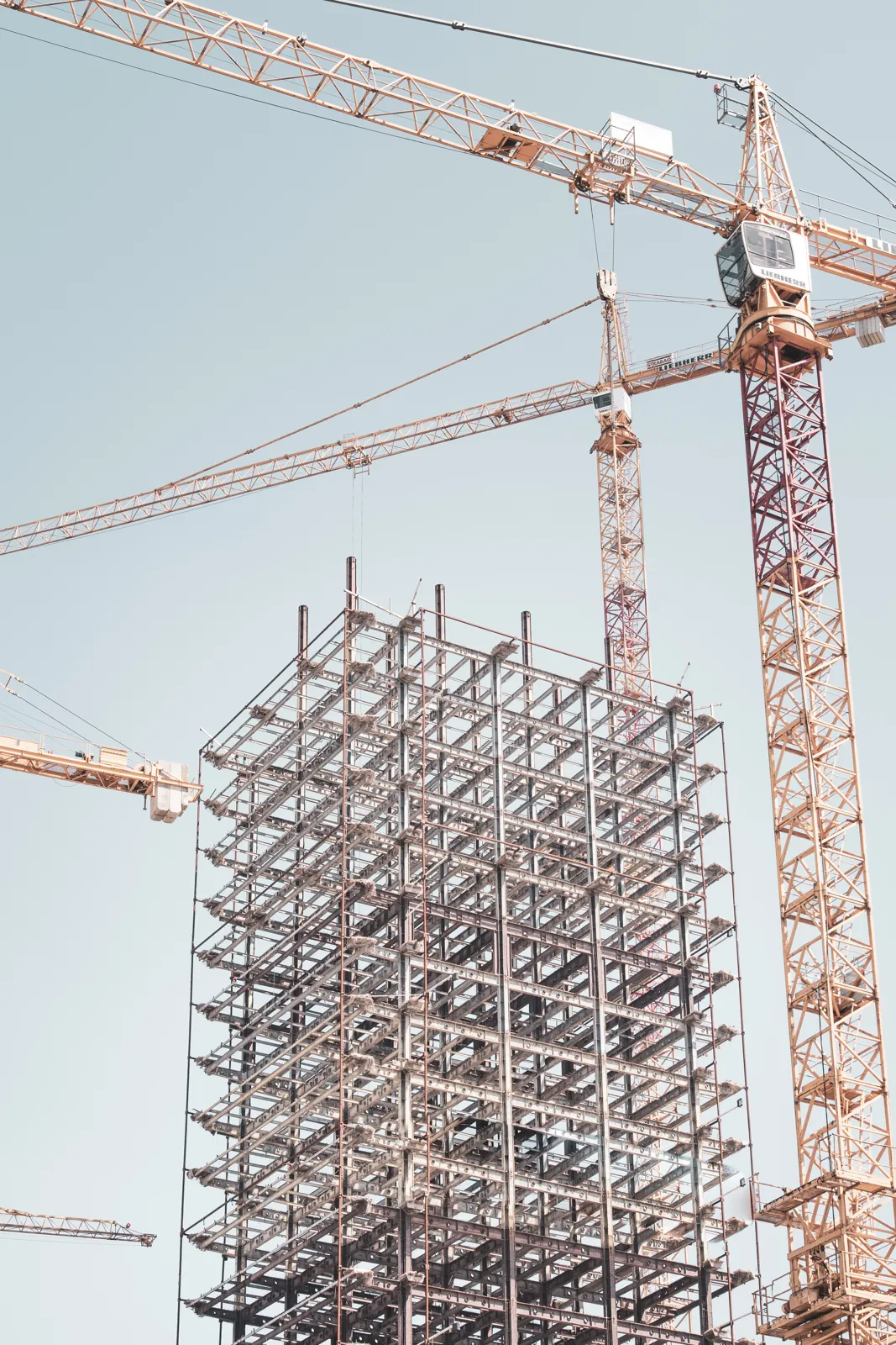 Tower cranes over a building under construction