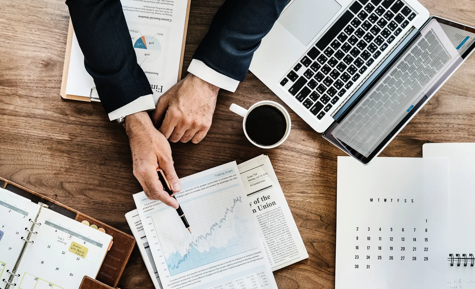 Commercial planning with charts and laptops